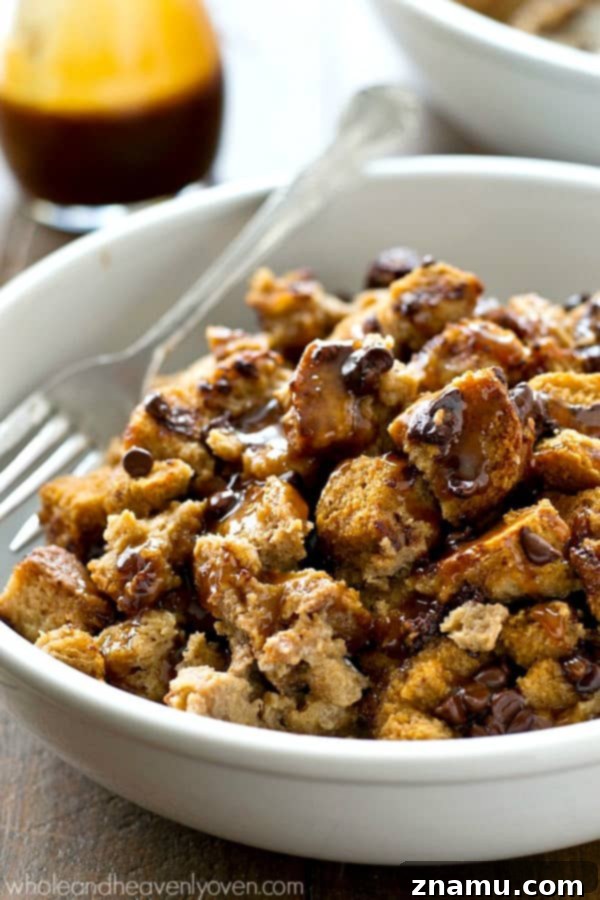 Warm Mocha Bread Pudding with Caramel Rum Drizzle 7 Close-up of a serving of coffee bread pudding, drizzled with rum caramel sauce, on a fork, highlighting the moist texture.