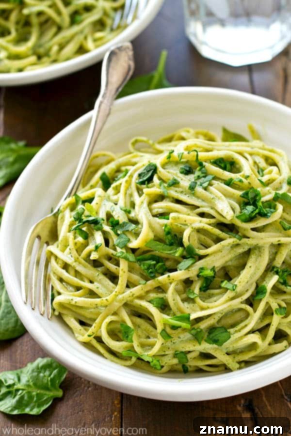 Guilt-Free Creamy Spinach Fettuccine Alfredo 7 Overhead shot of creamy green spinach alfredo sauce in a large saucepan, steaming slightly, indicating its freshness and warmth.