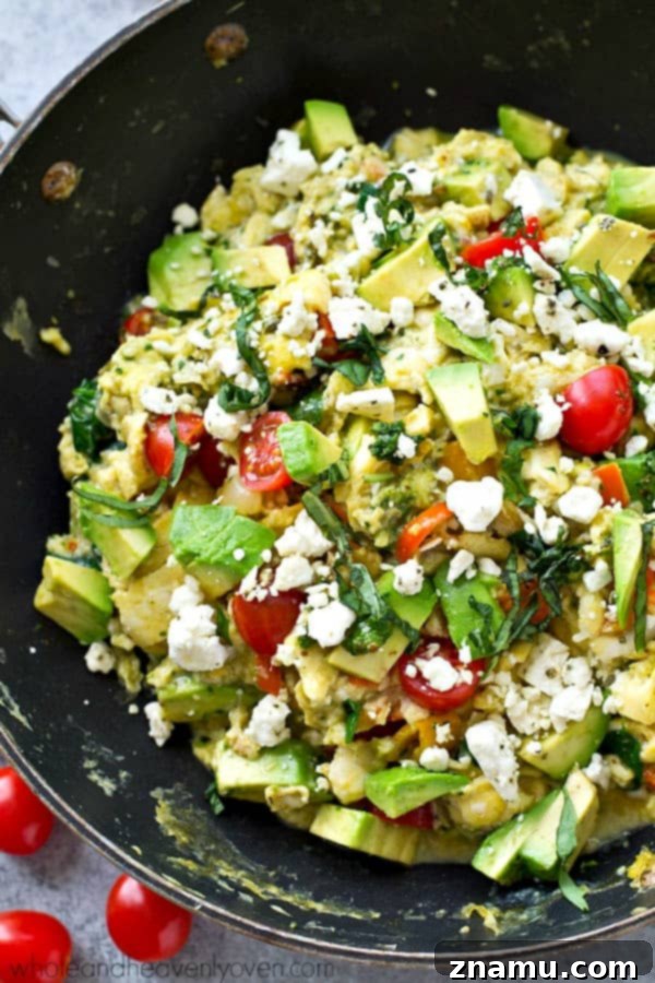 Pesto Garden Scramble 2 Colorful scrambled eggs with fresh garden vegetables and vibrant pesto