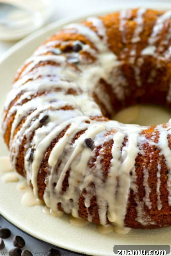 The absolute BEST classic sour cream coffee cake you'll ever have! Studded with gooey chocolate inside and covered with plenty of glaze.