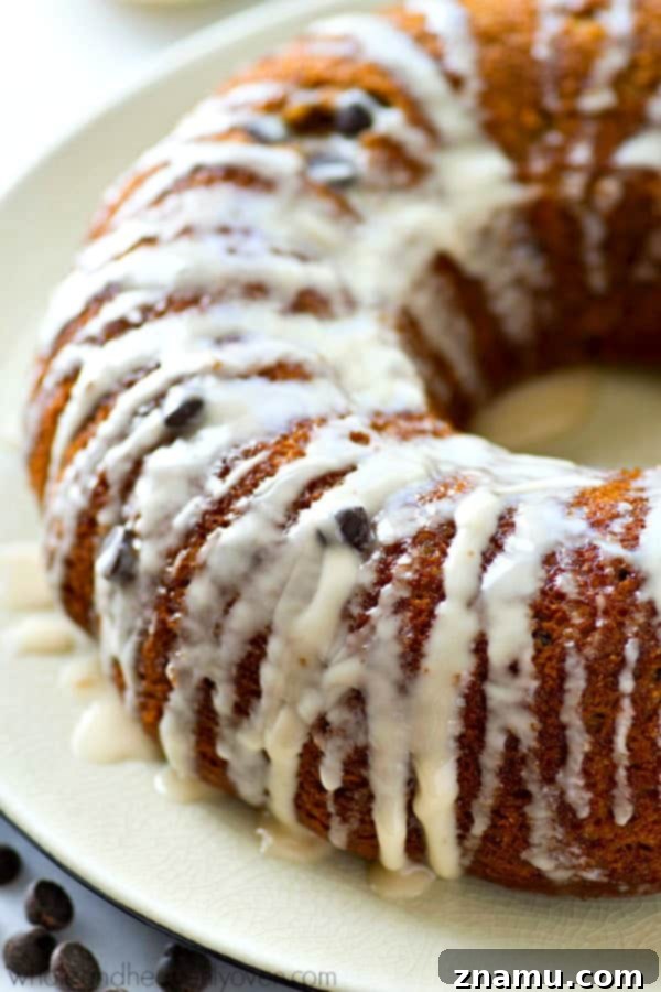 The absolute BEST classic sour cream coffee cake you'll ever have! Studded with gooey chocolate inside and covered with plenty of glaze.