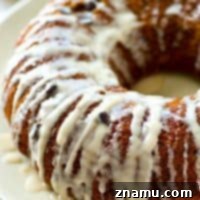 The absolute BEST classic sour cream coffee cake you'll ever have! Studded with gooey chocolate inside and covered with plenty of glaze.