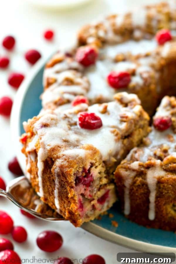 Swirled with a luscious cheesecake filling and topped with streusel and lots of glaze, this cranberry cheesecake swirl coffee cake is the ultimately impressive holiday breakfast!