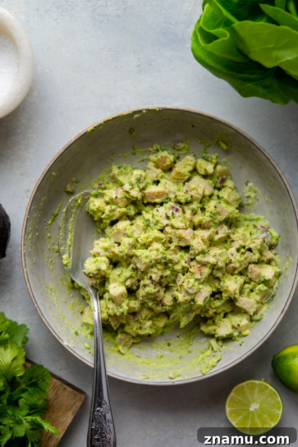 Avocado Chicken Lettuce Wraps 3 Close-up of the delicious avocado chicken salad mixture, with visible chunks of chicken, red onion, and fresh cilantro.