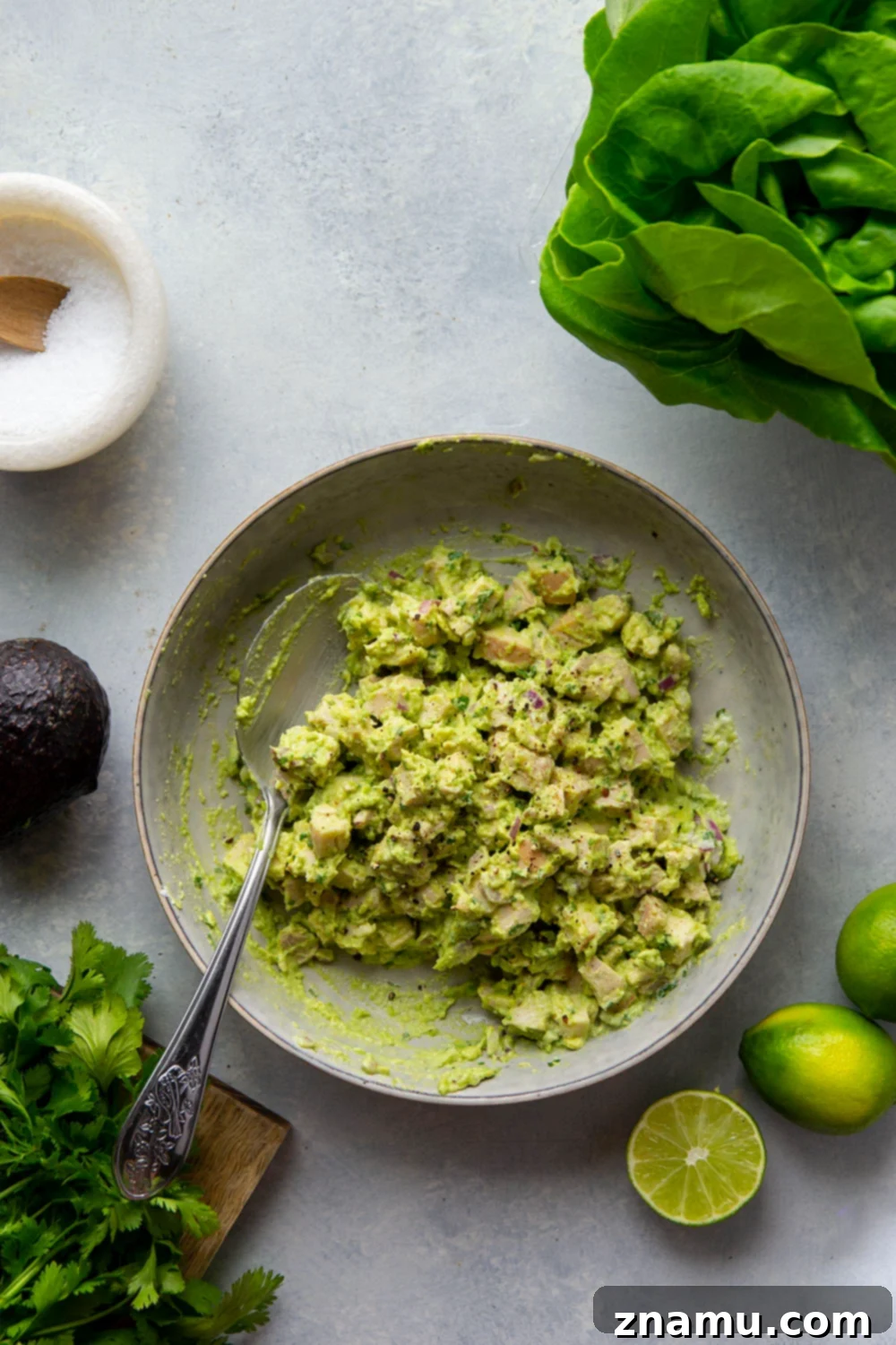 Avocado Chicken Lettuce Wraps 5 Assorted fresh ingredients for avocado chicken salad, including diced cooked chicken, a ripe avocado, and fresh lime.