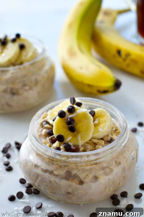 Chai Spiced Banana Overnight Oats 4 Side view of a glass jar filled with Banana Chai Spice Overnight Oats, showing layers of ingredients.