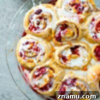 Zesty Orange Raspberry Swirl Buns 9 Orange Raspberry Swirl Cinnamon Rolls recipe image.