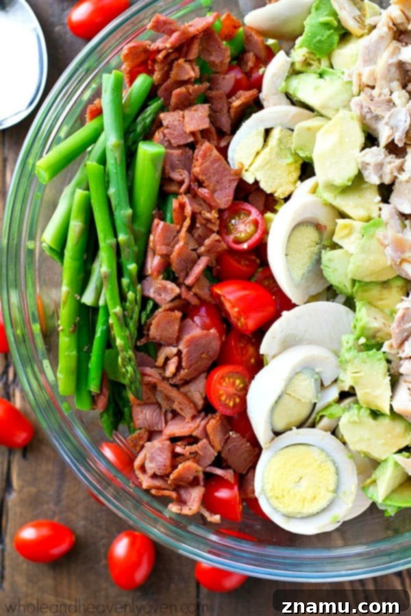 Bright Asparagus Cobb Salad with a Tangy Red Wine Vinaigrette 4 Overhead shot of a richly assembled Springtime Asparagus Cobb Salad in a large bowl, ready to be served