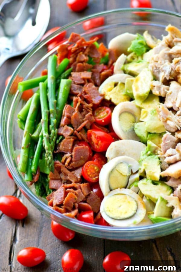 Bright Asparagus Cobb Salad with a Tangy Red Wine Vinaigrette 5 Individual ingredients for Springtime Asparagus Cobb Salad neatly arranged, including asparagus, chicken, bacon, eggs, and feta