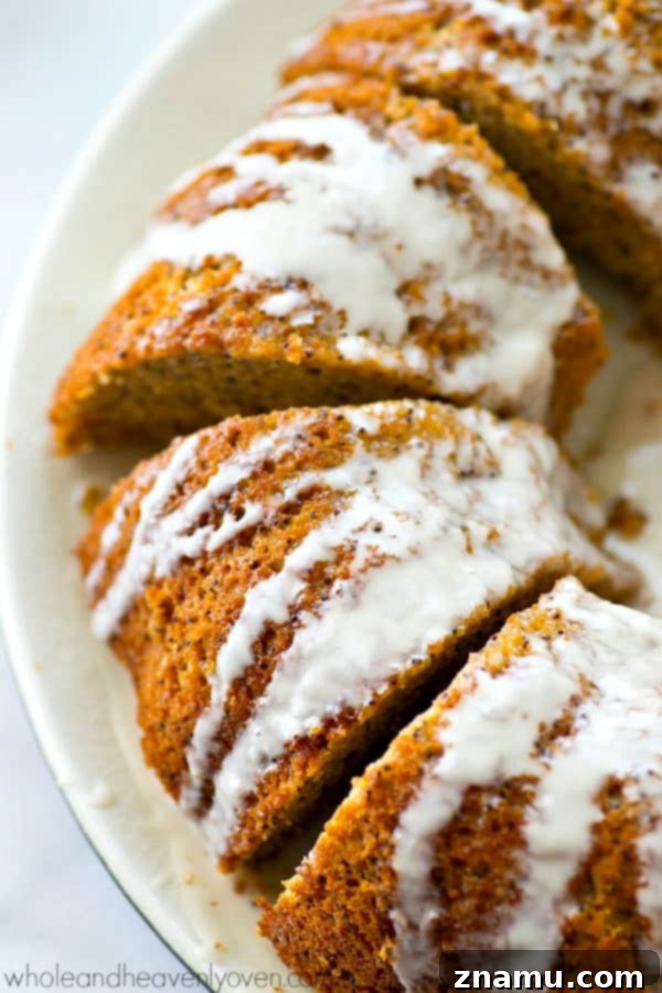 Airy Lemon Poppyseed Bundt Delight 2 A vibrant yellow lemon poppyseed bundt cake, perfectly glazed and studded with poppyseeds, presented on a white plate ready to be served. Ideal for spring gatherings.