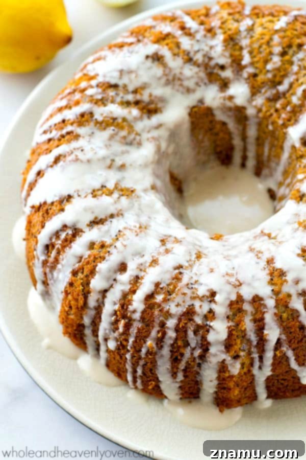 Airy Lemon Poppyseed Bundt Delight 6 Close-up of a slice of bundt cake, perfectly cut, showing the soft, golden interior and even distribution of poppyseeds, ready to be enjoyed.