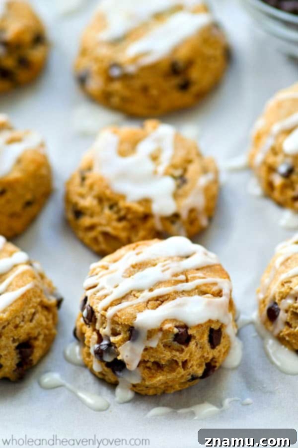 Mini Frosted Chocolate Chip Cookies 4 A stack of golden brown Mini Frosted Chocolate Chip Biscuits, glistening with a sweet white glaze, ready to be enjoyed.