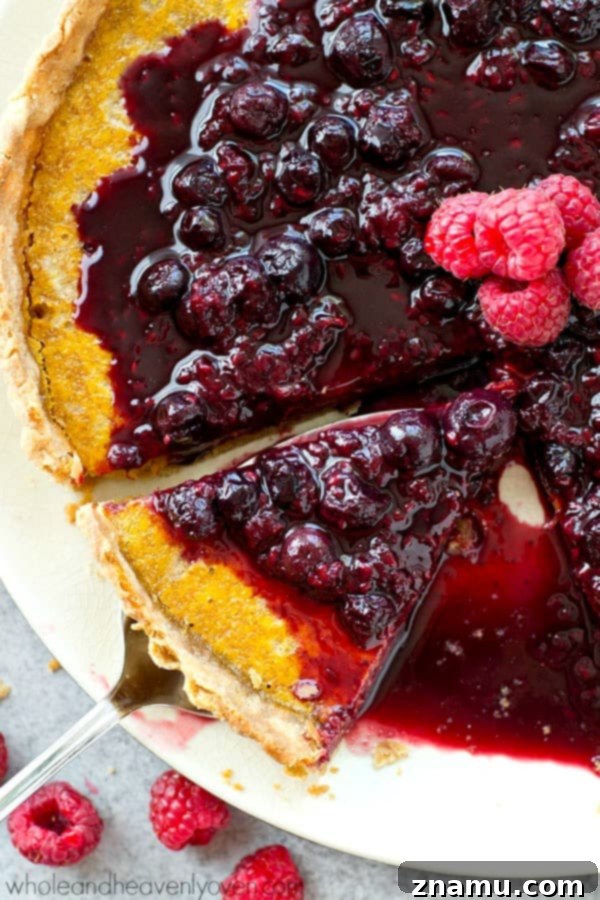 Close-up of a perfectly baked lemon tart slice, showcasing the creamy filling.