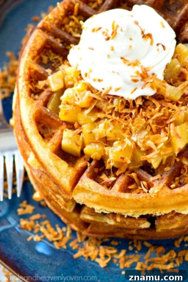 Tropical Overnight Waffle Bliss 3 Close-up of golden crispy yeast waffles on a plate, ready to be topped.