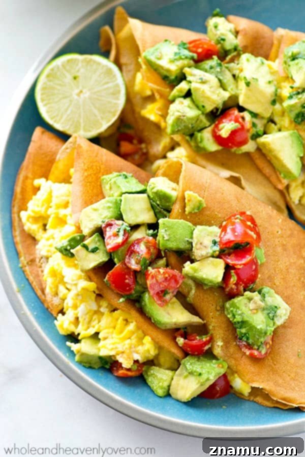 Gourmet Savory Crepes: Scrambled Eggs & Zesty Avocado Pico 3 Close-up of a stack of savory scrambled egg crepes with fresh avocado pico de gallo, showcasing the vibrant colors and appealing texture.