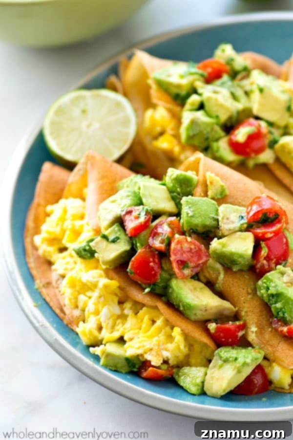 Gourmet Savory Crepes: Scrambled Eggs & Zesty Avocado Pico 4 Hands holding a single savory crepe, folded into quarters and revealing the scrambled egg filling and a dollop of avocado pico de gallo.