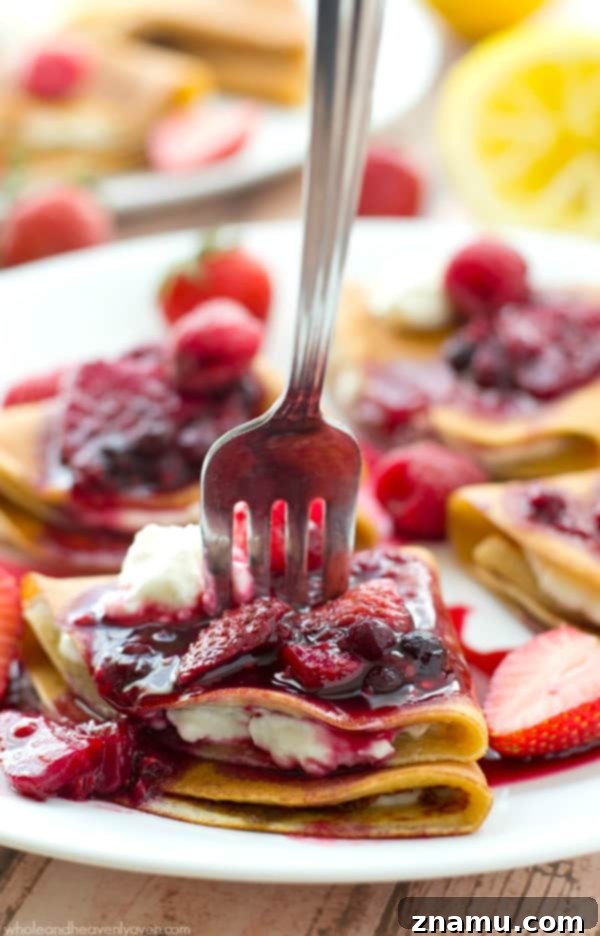 Gourmet Savory Crepes: Scrambled Eggs & Zesty Avocado Pico 10 Sweet crepes filled with tangy lemon cream cheese and topped with a vibrant triple-berry sauce, presented beautifully for a spring brunch.
