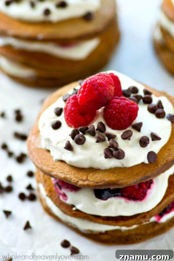 Decadent Mini Chocolate Raspberry Pancake Stacks 2 Fresh raspberries, whipped cream, and mini chocolate chips stuffed between 3 layers of ultra-fluffy mini chocolate pancakes! These pancake stacks are a brunch must-have.