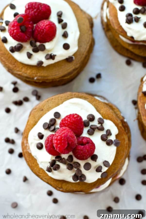Decadent Mini Chocolate Raspberry Pancake Stacks 3 Fresh raspberries, whipped cream, and mini chocolate chips stuffed between 3 layers of ultra-fluffy mini chocolate pancakes! These pancake stacks are a brunch must-have.