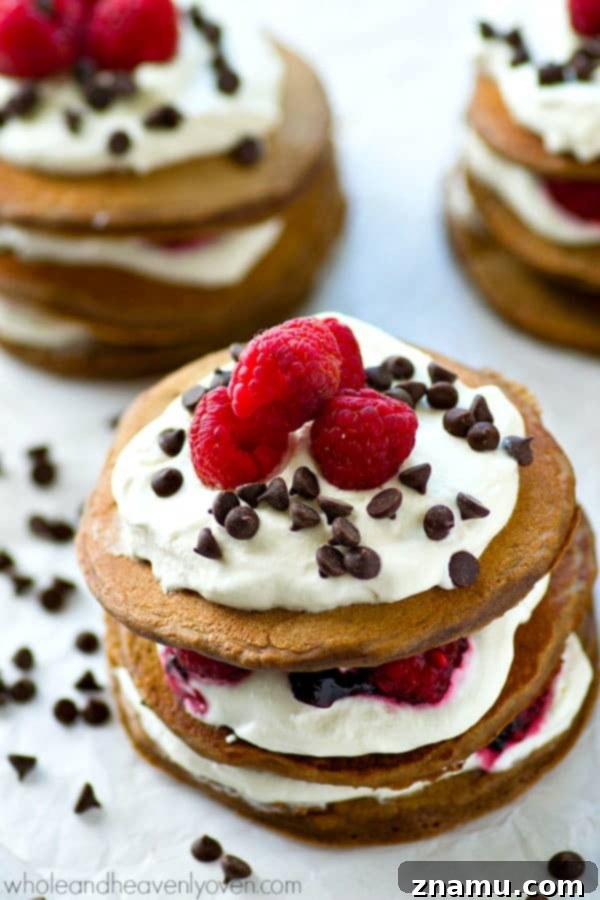 Decadent Mini Chocolate Raspberry Pancake Stacks 4 Fresh raspberries, whipped cream, and mini chocolate chips stuffed between 3 layers of ultra-fluffy mini chocolate pancakes! These pancake stacks are a brunch must-have.