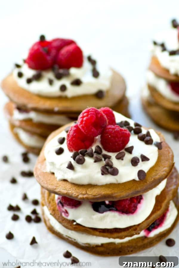 Decadent Mini Chocolate Raspberry Pancake Stacks 7 Fresh raspberries, whipped cream, and mini chocolate chips stuffed between 3 layers of ultra-fluffy mini chocolate pancakes! These pancake stacks are a brunch must-have.