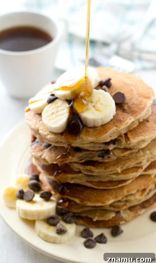 Decadent Mini Chocolate Raspberry Pancake Stacks 9 Fluffy banana oatmeal pancakes studded with gooey chocolate chips. A hearty and healthy breakfast perfect for any morning.