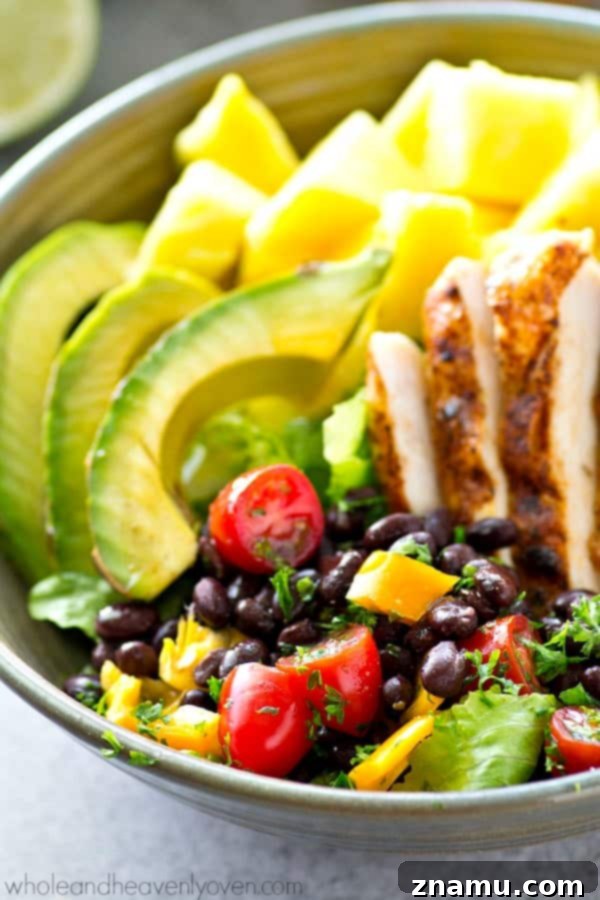 Vibrant Tropical Grilled Chicken Mexican Salad Bowls 4 A selection of fresh ingredients for the Tropical Grilled Chicken Mexican Salad, including raw pineapple, uncooked chicken, black beans, tomatoes, and cilantro, ready for preparation.