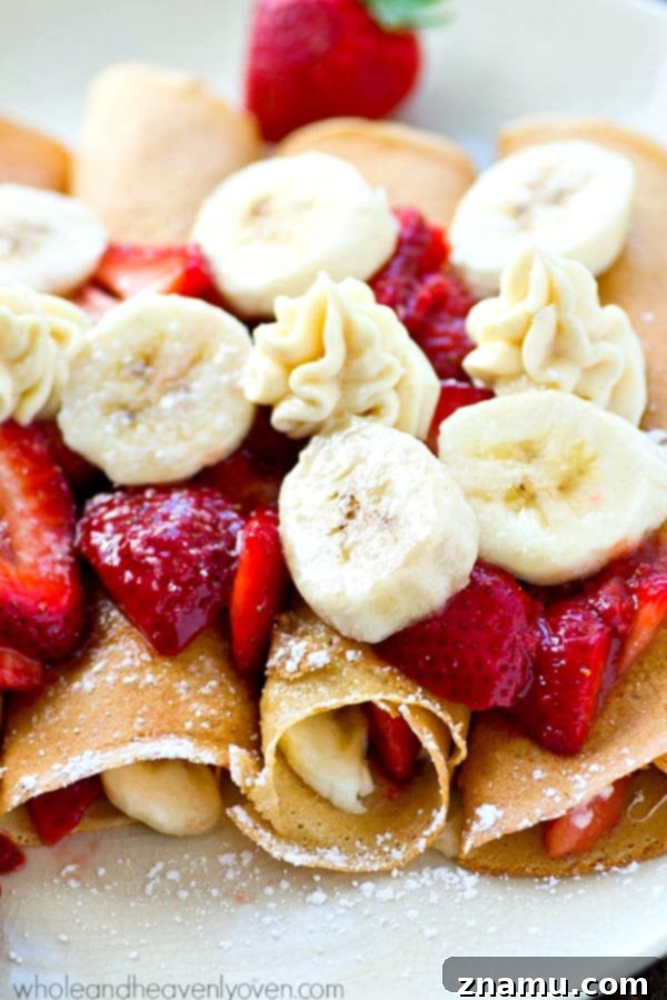 Hands carefully preparing the Strawberry Banana Cheesecake Crepes, gently adding the rich filling.