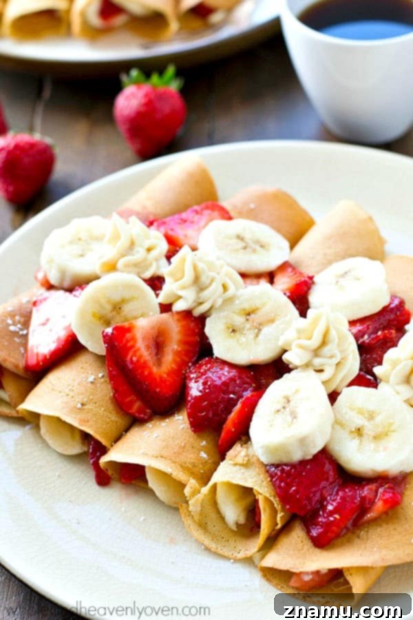 A beautiful stack of golden-brown crepes, perfectly cooked and ready to be filled with the sweet cheesecake mixture.