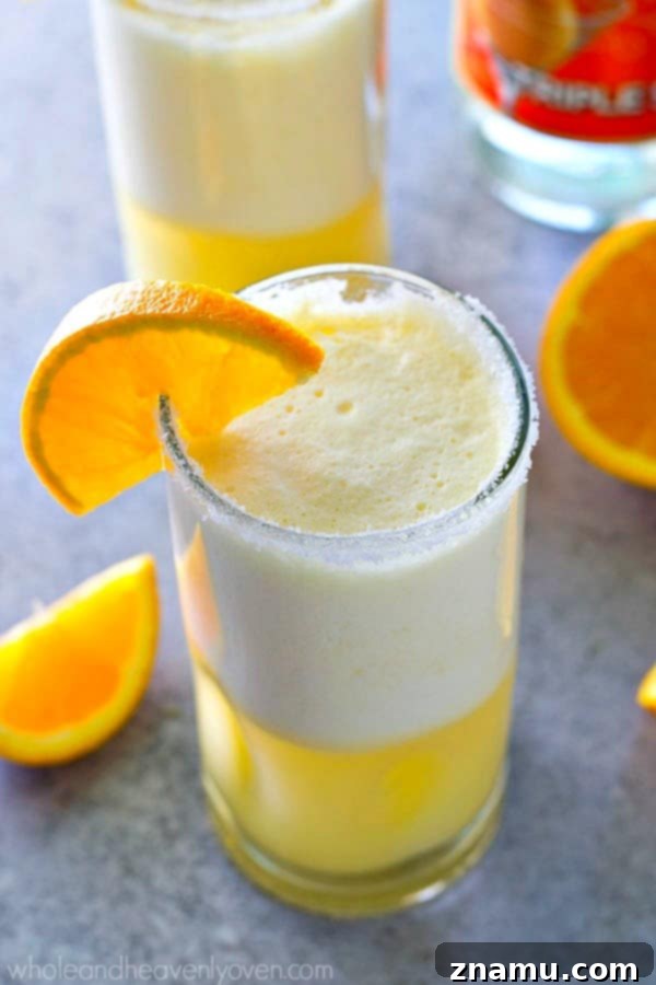 Creamy, citrus-y and perfectly frosty, these cocktail slushies are like an orange creamsicle in boozy adult form!---The perfect summer cocktail. 
