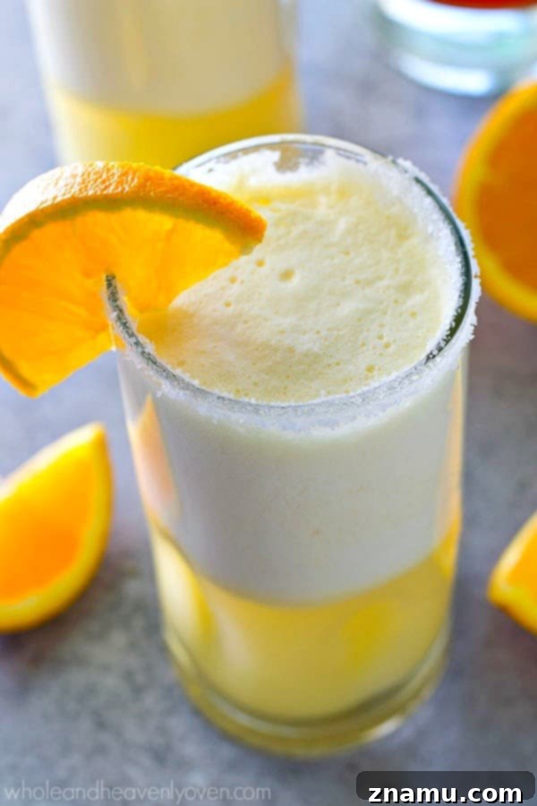 A vibrant Orange Creamsicle Cocktail Slushie, a delightful alcoholic summer beverage.