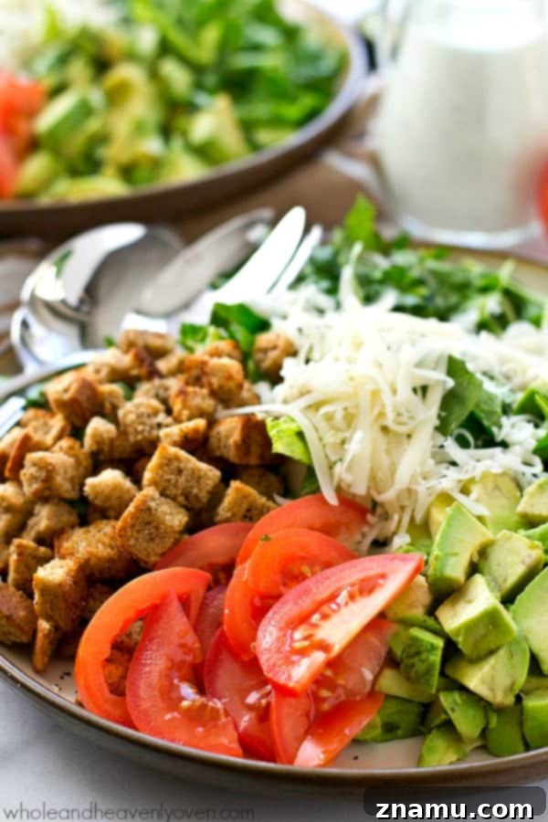 Healthy Caesar salad with avocado, spinach, and a light buttermilk dressing