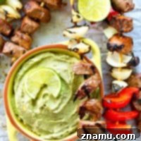 Simple grilled steak and pepper kebabs with just a little kick of spice that go perfectly with a cool and creamy avocado dip.---These steak kebabs are SO easy to make!