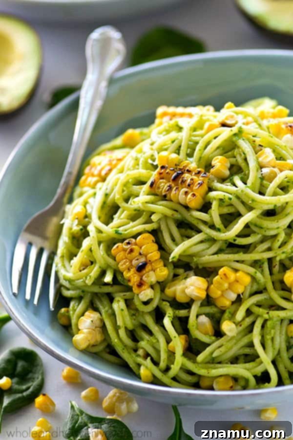 Creamy Avocado Pesto Spaghetti with Smoky Grilled Corn 4 Close-up of creamy avocado pesto spaghetti with fresh basil and grilled corn.