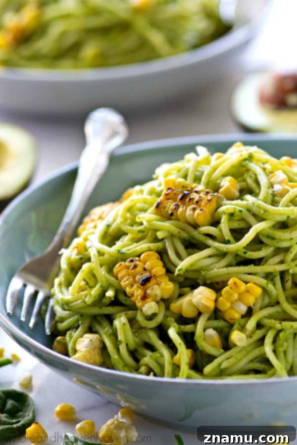 Creamy Avocado Pesto Spaghetti with Smoky Grilled Corn 5 Serving of avocado pesto spaghetti with grilled corn, ready to be enjoyed.