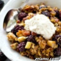 Juicy blackberries and tangy rhubarb are a match made in heaven together in this summery crumble that's piled high with a buttery almond streusel topping.---Don't forget the whipped cream on top!
