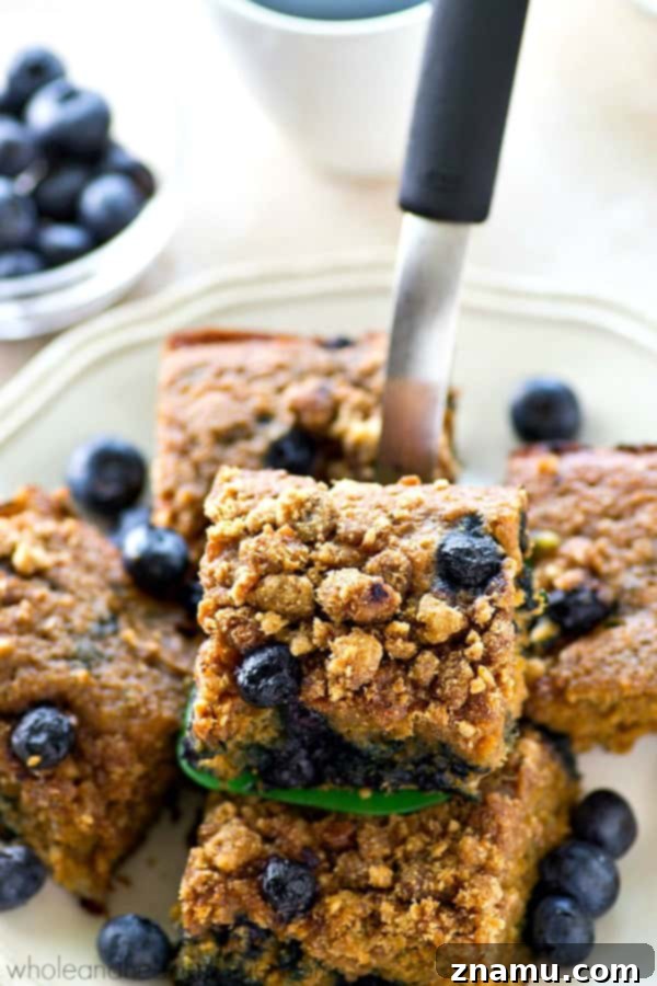 Close-up of the golden-brown streusel topping on a blueberry banana coffee cake, showcasing its generous crumbly texture.