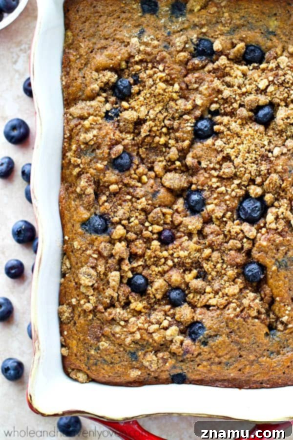 A beautifully baked blueberry banana coffee cake, fresh out of the oven, with a thick layer of streusel.