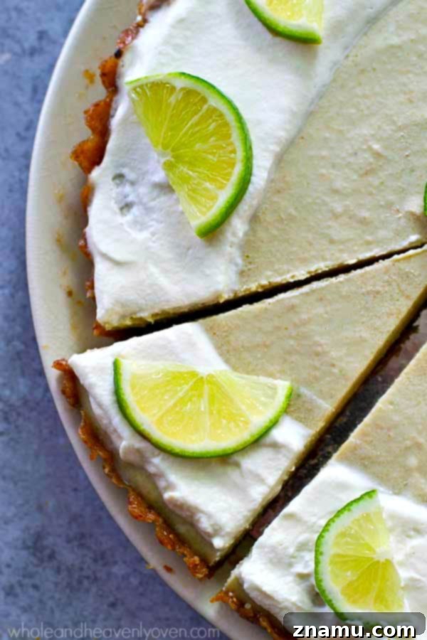 Effortless Key Lime Cheesecake Tart 7 A large slice of no-bake key lime cheesecake tart on a plate