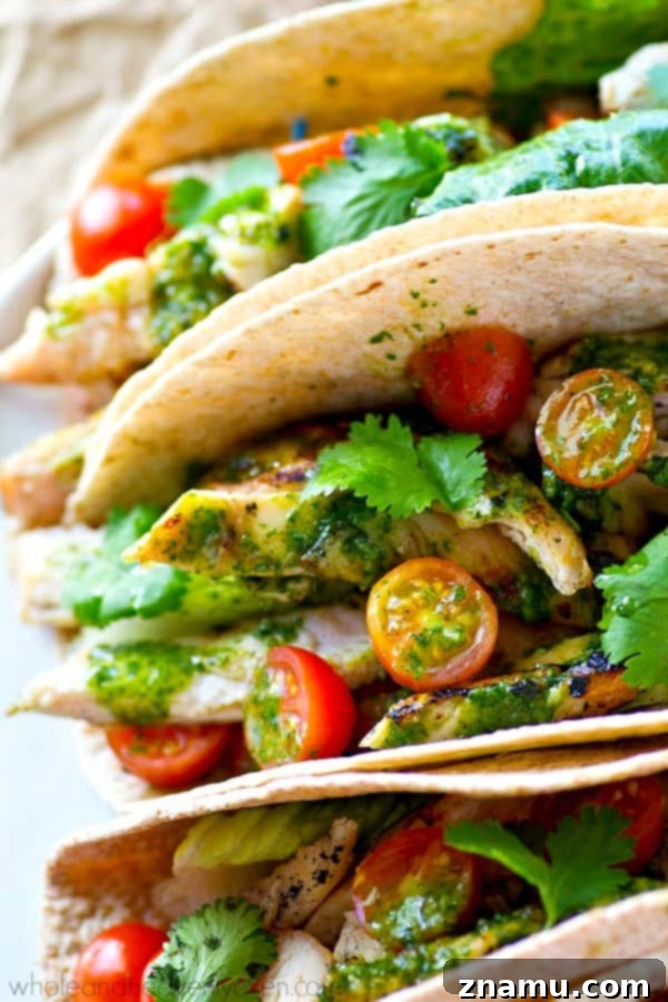 Chargrilled Greek Chicken Tacos with Fresh Herb Chimichurri 6 Grilled Greek chicken slices ready to be assembled into tacos, showing the perfect char.