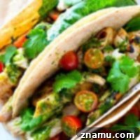 A flavorful greek marinade and plenty of zesty homemade chimichurri sauce take these grilled chicken tacos over the top in summer flavors! These tacos are so easy, they'll have a permanent spot on your dinner menu!
