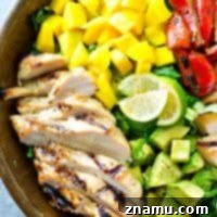 Hawaiian-style grilled chicken, sweet mango, and a tangy citrus dressing bring out all the BEST fresh flavors in this gorgeous summer salad! It's almost too pretty to eat.