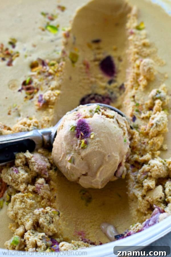 Roasted Cherry Pistachio Ice Cream A scoop of homemade roasted cherry pistachio ice cream with a hot fudge drizzle, a perfect summer dessert.