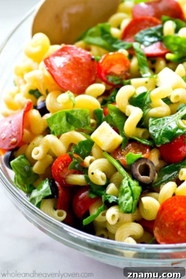 Fresh ingredients combined for a vibrant Italian Pizza Pasta Salad