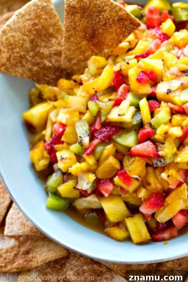 Caramelized Pineapple Salsa with Spiced Cinnamon Chips 3 Grilled Pineapple Salsa served in a large bowl with an abundance of cinnamon tortilla chips, perfect for a summer snack table.