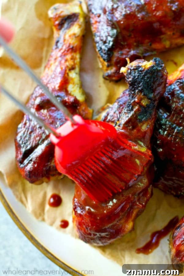 Homemade Grilled BBQ Chicken: A Sizzling Success Story 6 Grilled chicken pieces being generously brushed with homemade BBQ sauce