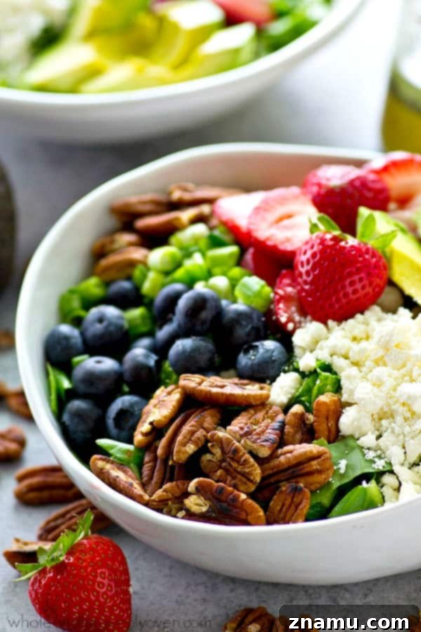Berry Blast Power Greens with Orange Poppyseed Zest 5 A serving of the mixed berry power salad, highlighting the fresh berries and greens.