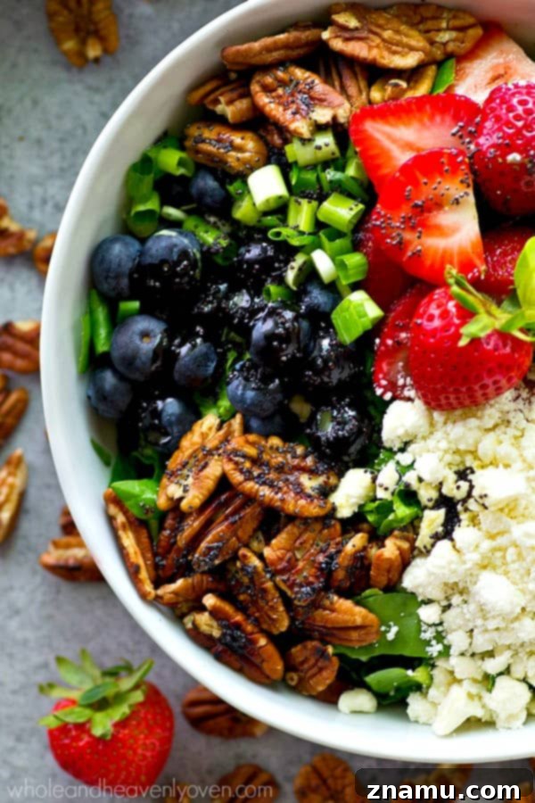 Berry Blast Power Greens with Orange Poppyseed Zest 6 A delicious bowl of berry power salad, combining fresh fruits, nuts, and greens.