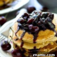 Southern-style citrus cornmeal pancakes with cherry compote