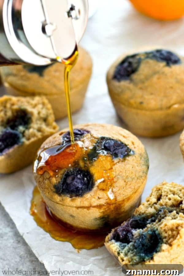 Delicious blueberry pancake muffins drizzled with warm citrus maple syrup, a quicker alternative to traditional pancakes.